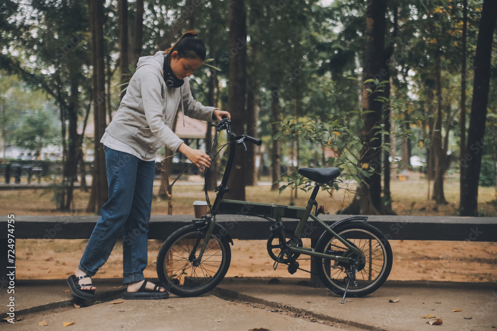 Obraz premium Happy Asian young woman walk and ride bicycle in park, street city her smiling using bike of transportation, ECO friendly, People lifestyle concept.