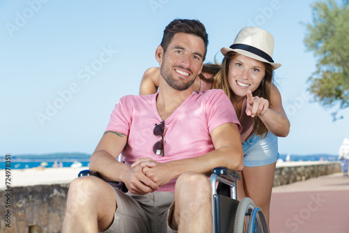 couple by the seaside man in wheelchair © auremar
