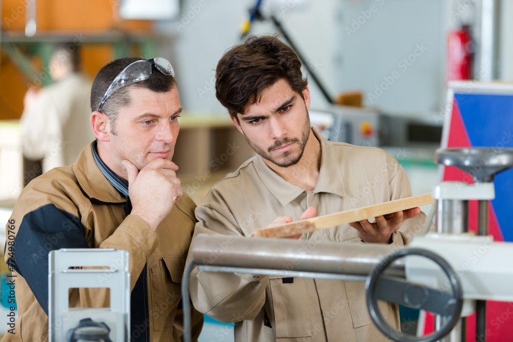 Fotografie two men in workwear in a carpenters workshop
