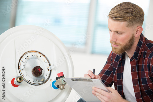 male worker checking a gas boiler