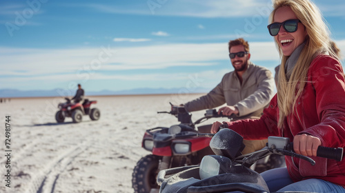 Tourists crossing a salt desert with a quad bike