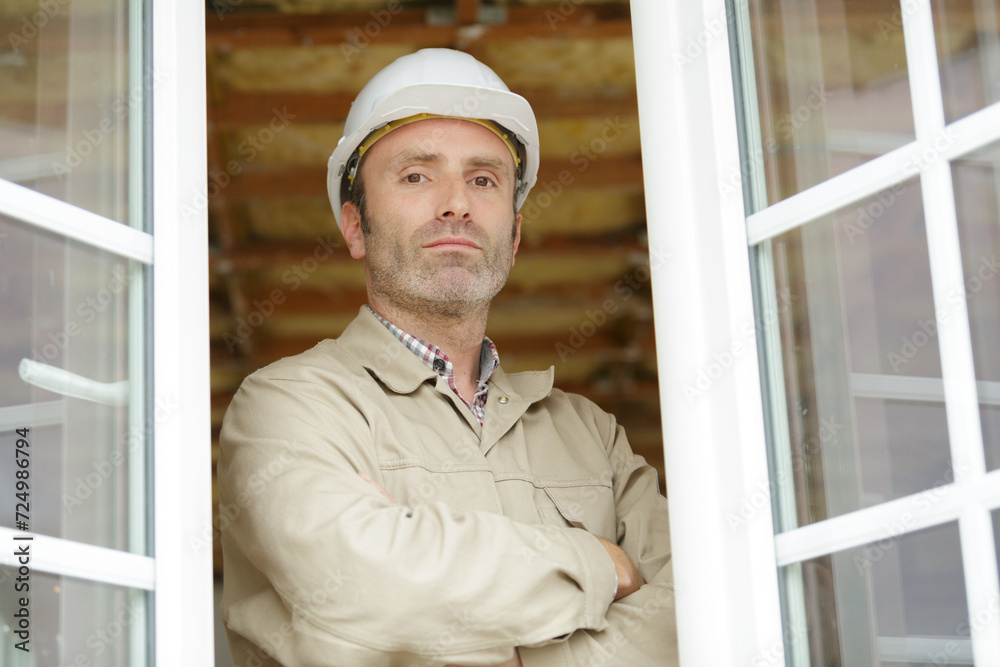 construction worker using drill to install window construction worker using drill to install window