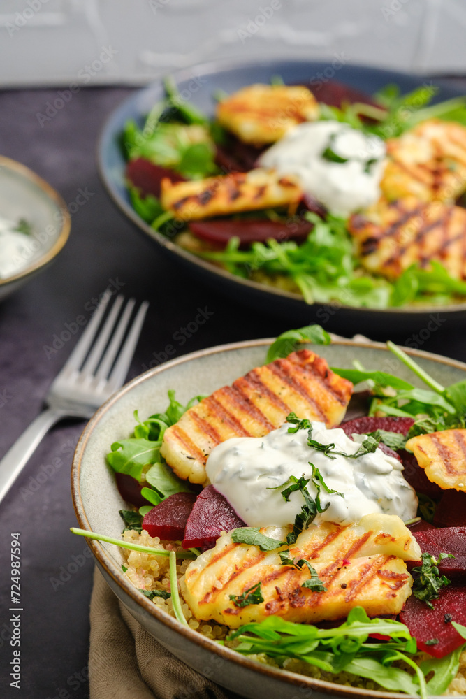 Vegetarian Grilled Halloumi Quinoa Salad with Beetroot. Healthy Mediterranean Food Concept. Vertical Close-up. Vegetarian Grilled Halloumi Quinoa Salad with Beetroot. Healthy Mediterranean Food Concept. Vertical Close-up.