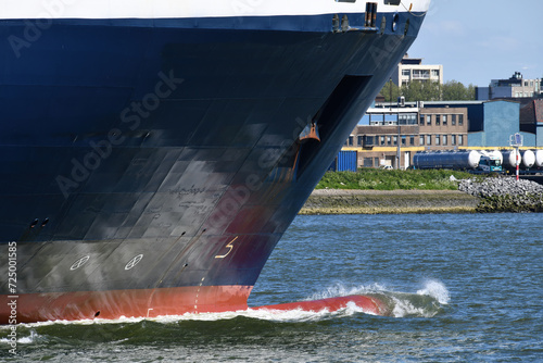 Close up of the bow of a cargo ship with the bulbous bow pushing aside the water in the Nieuwe Waterweg near Maassluis, The Netherlands photo