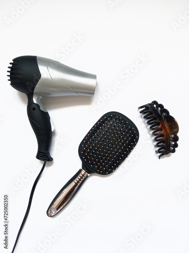 hair dryer, comb and hair clip on white background, hair care