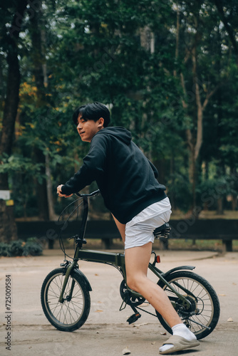 Handsome happy young man with bicycle on a city street, Active lifestyle, people concept © ARMMY PICCA
