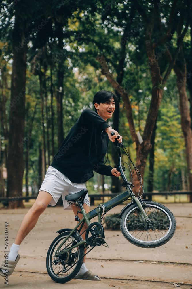 Handsome happy young man with bicycle on a city street, Active lifestyle, people concept