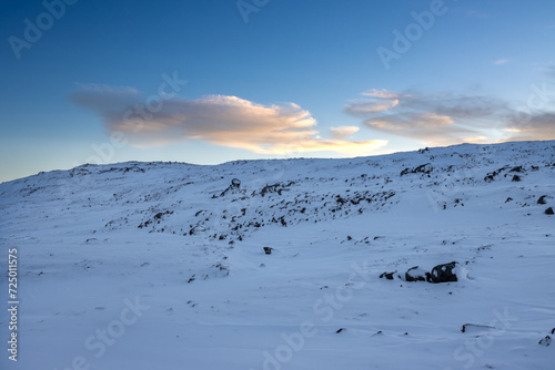 Snowy mountains during early sunset, Iceland © yassmin