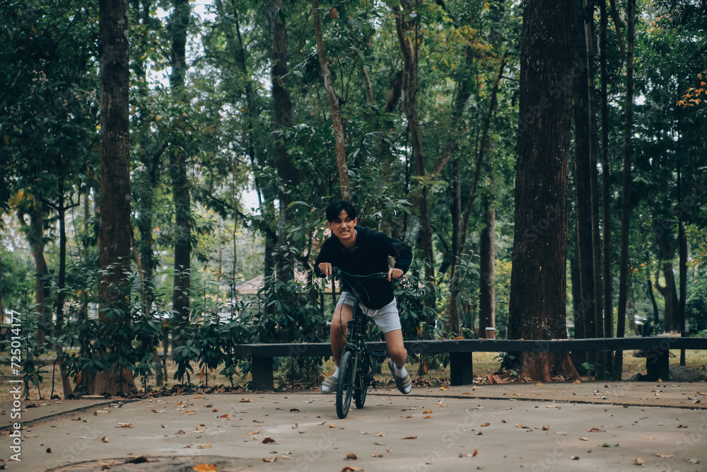 Fototapeta premium Handsome happy young man with bicycle on a city street, Active lifestyle, people concept