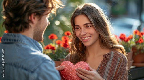man gives his beloved girlfriend a heart-shaped box