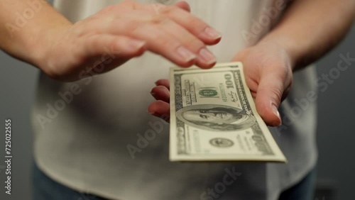 Funny video of female hands scattering hundred dollar bills. Close-up slow motion video of money flying out of hands. High quality 4k footage