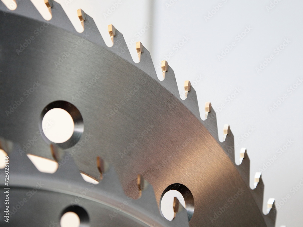 Circular disk saw Wood cutter fragment closeup with hardened cogs. A carpenter tools for a woodworking machine.