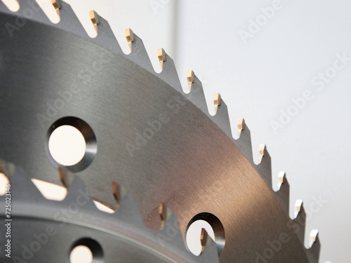 Circular disk saw Wood cutter fragment closeup with hardened cogs. A carpenter tools for a woodworking machine.