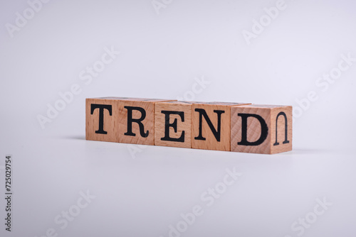 The inscription Trend made of wooden cubes on a plain background
