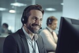 A man wearing a headset sitting in front of a computer. Perfect for customer service or remote work concepts