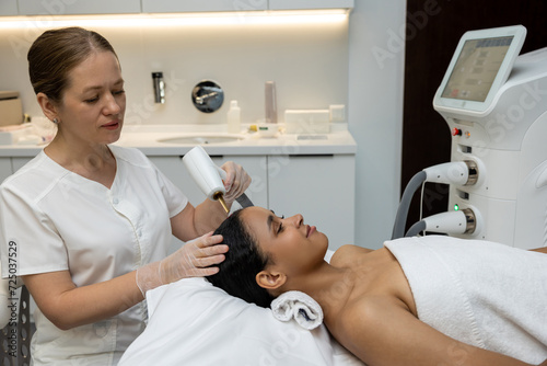 Customer in a beauty clinic having anti hair loss procedures