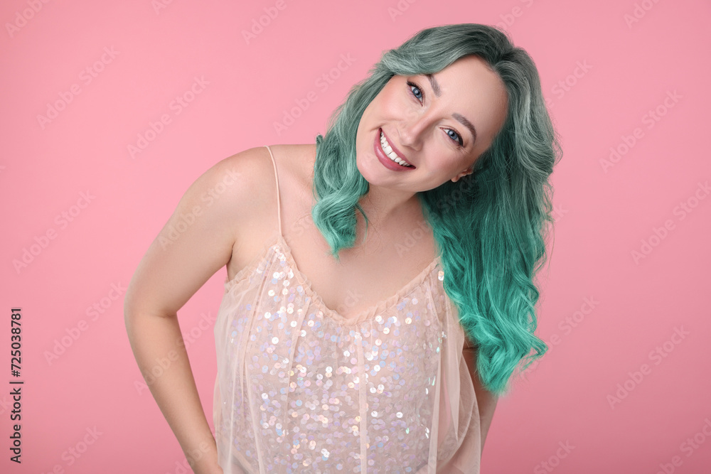 Trendy hairstyle. Young woman with colorful dyed hair on pink background Trendy hairstyle. Young woman with colorful dyed hair on pink background