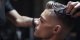 A man is pictured getting his hair cut at a barber shop. This image can be used to showcase professional hair grooming services