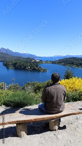 Man on bench enjoying patagonia landscape