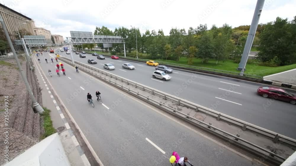 Cyclists and cars drive along Lefortovo embankment during bicycle parade Cyclists and cars drive along Lefortovo embankment during bicycle parade