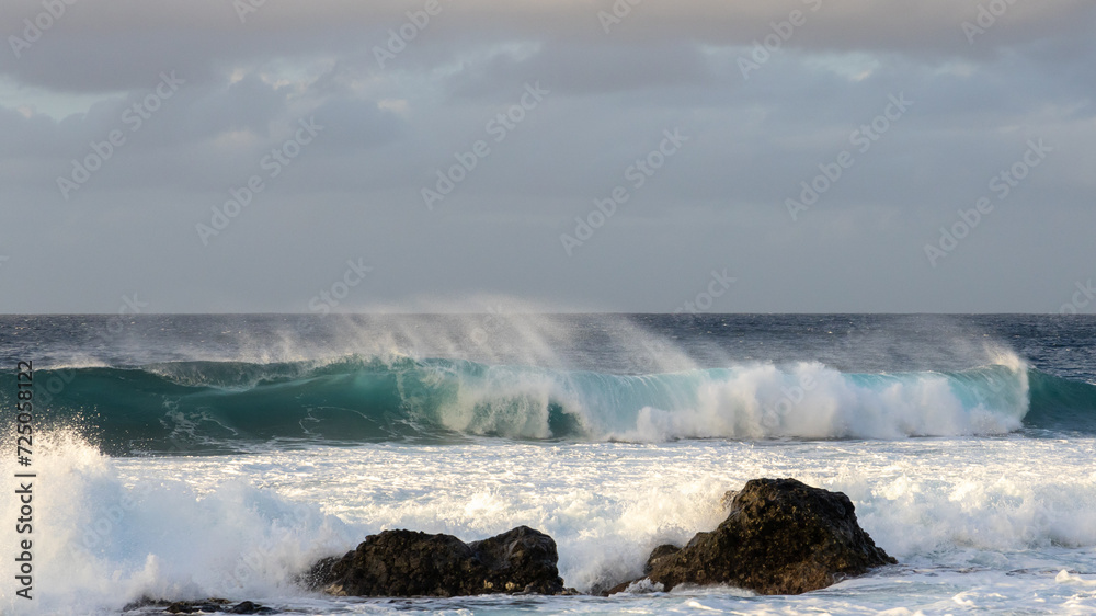 Waves rolling in over volcanic rock in Puert de las Nieves, Gran Canaria, Spain