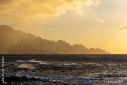 Sea and mountains near Agaete  Gran Canaria  Spain. Landscape light and shade on hillside in sunset