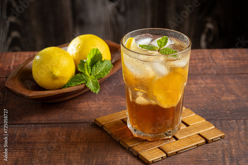 Glass of iced tea with lemon and mint.