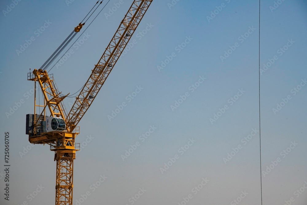 one single construction crane against blue sky one single construction crane against blue sky