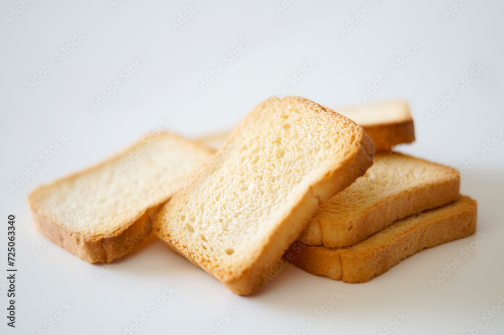 Close-up view of toasted bread on white background Close-up view of toasted bread on white background