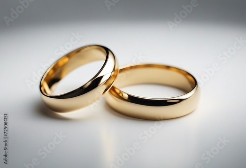 Pair of simple gold Wedding ring on a grey background macro shot