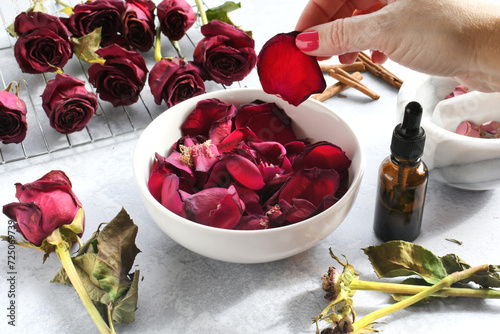 Making homemade rose potpourri by drying roses petals and adding essential oils spices, DIY photo