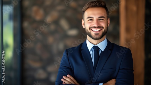 Handsome businessman in blue suit smiling at camera