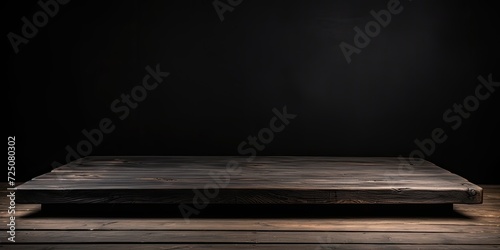 Black wood table for placing objects on a black background with a 45-degree side view. photo