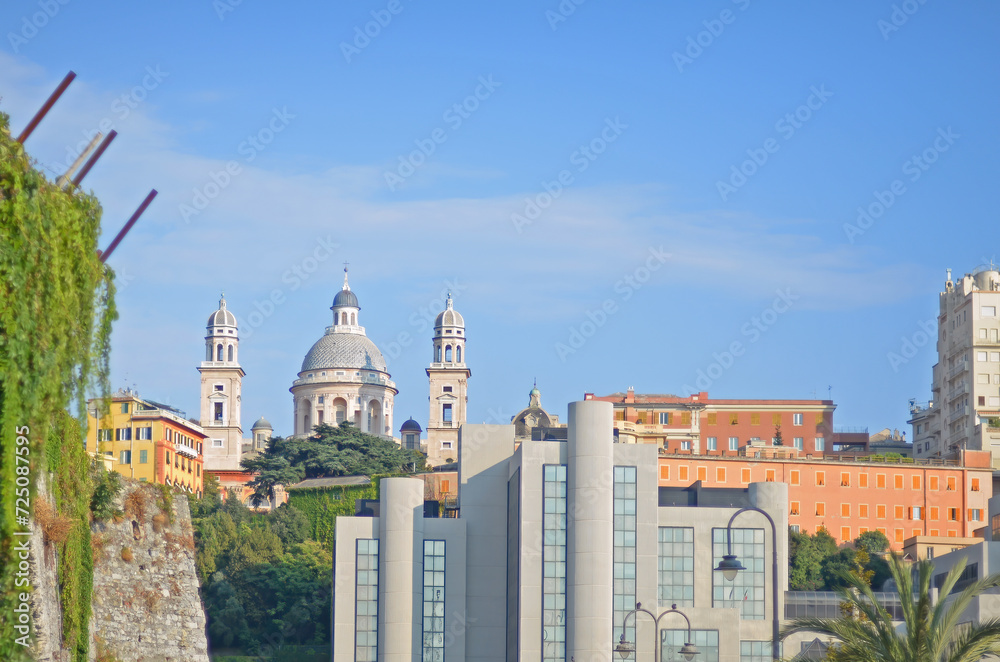 The Carignano district in Genoa, with old and new buildings and the basilica Santa Maria Assunta in renaissance style on a bright day with blue sky