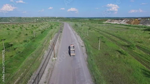 Truck rides by contry road near railway at summer sunny day. Aerial view photo