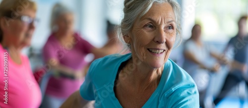 Senior woman receiving fitness coaching from a female instructor, while a diverse group of elderly individuals engage in a nursing home fitness class under guidance.