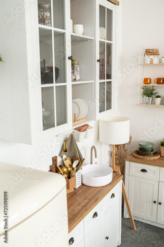 White kitchen interior with wooden worktop © dmshpak
