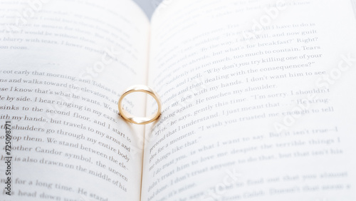 Wedding rings on an open book. Selective focus.