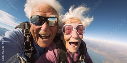 an elderly couple takes a selfie while skydiving