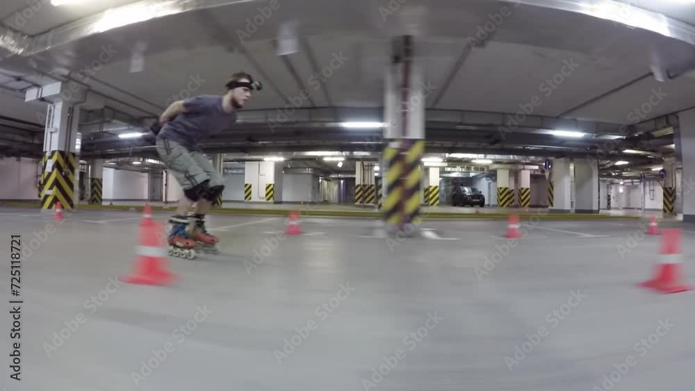 Man on roller skates take run and ride along cones on underground car parking. Man on roller skates take run and ride along cones on underground car parking.