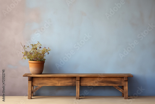 Rustic wood bench against soft blue stucco wall with copy space photo