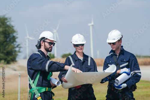 engineers working in fieldwork outdoor. Workers walking and inspect construction and machine around project site. Wind turbine electrical of clean resource enerdy and environment sustainable.
