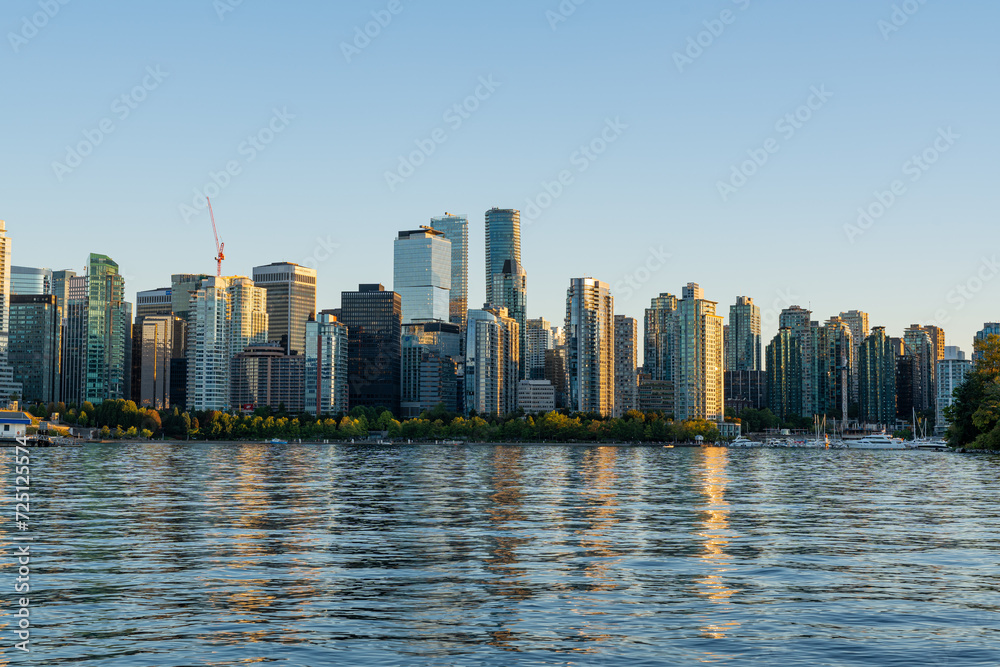 The Vancouver, British Columbia city skyline and Vancouver Harbor at sunset as viewed from Stanley Park. 