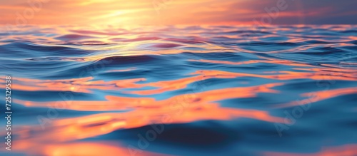 The water reflects orange and blue skies during sunrise.