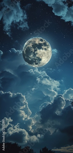 A mesmerizing view of a full moon illuminating a night sky with scattered clouds, ideal for a mystical lock screen wallpaper. © Amazing-World