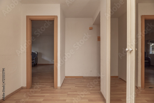 Small hall of a home with light-colored floors  a built-in wardrobe