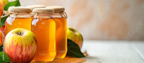 White background, glass jar with apple juice.