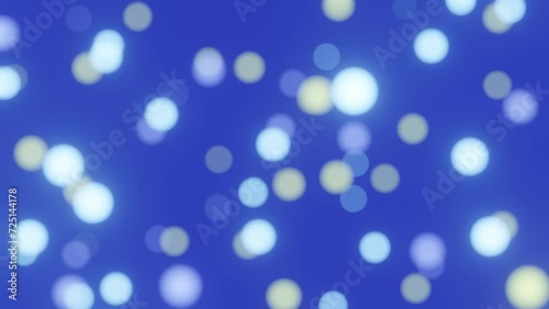 Defocused bokeh particles lights on blue background 4K loop