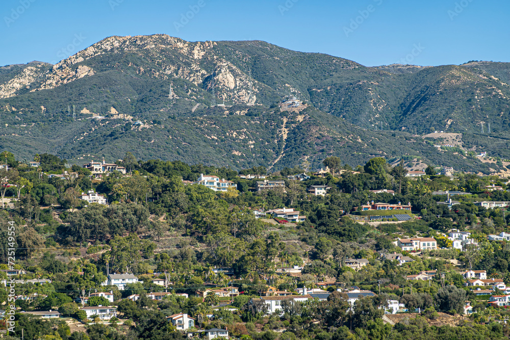 Santa Barbara, CA, USA - November 30, 2023: Santa Barbara County Courthouse lookout tower view on Riviera mansions on green hill flank with Santa Ynez mountains and blue sky