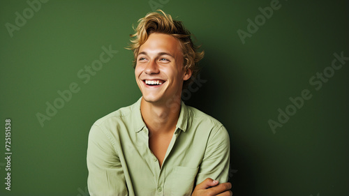 Happy smiling young adult man on a solid background
